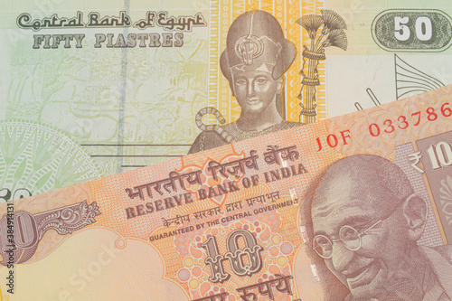 Wallpaper Mural A macro image of a orange ten rupee bill from India paired up with a green and yellow fifty piastre note from Egypt.  Shot close up in macro. Torontodigital.ca