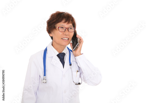 Female doctor in front of white background is answering the phone