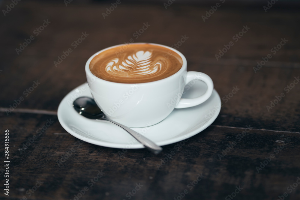 Fototapeta premium cup of coffee on wooden table in vintage style