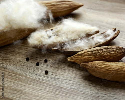 kapok seeds ( ceiba pentandra) on wood texture background photo