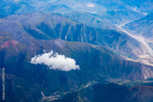 Aerial view above the clouds and mountain peaks on a sunny day.mountain view from airplane.