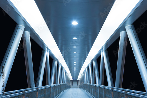 Modern empty foot bridge in the dark. Building abstract background
