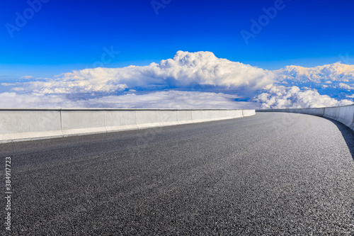 Empty asphalt road and blue sky with white clouds scenery.