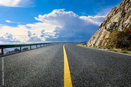Asphalt road and mountain with sky clouds landscape. © ABCDstock