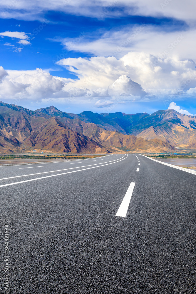 Fototapeta premium Asphalt road and mountain with sky clouds landscape.