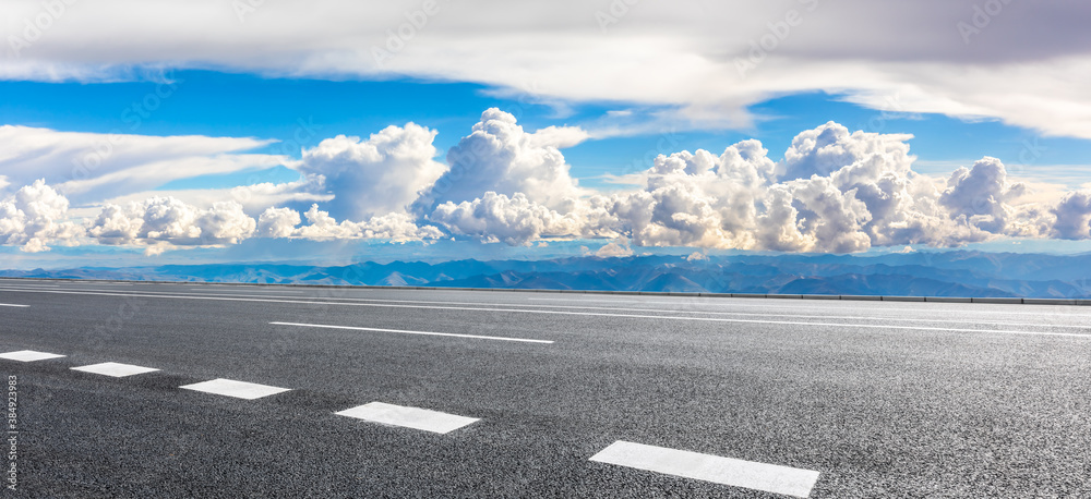 Fototapeta premium Asphalt road and mountain with sky clouds landscape.