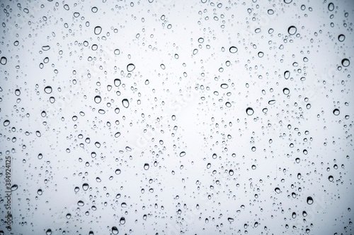 Water drops on car glass, raining drops on clear window, abstract backgrounds.