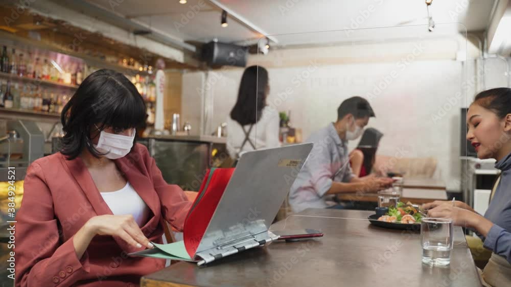 Young female customer dining in restaurant sit social distancing table Young female customer dining in restaurant sit social distancing table