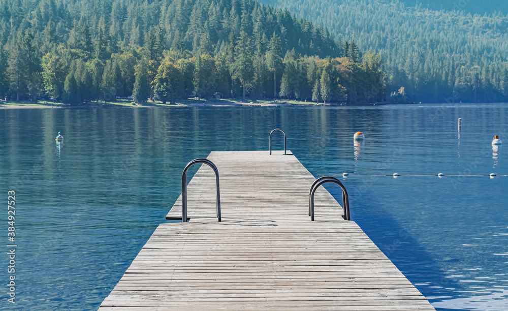 A wooden dock at the beautiful Cultus Lake, British Columbia. Travel photo, selective focus, copy space for text.