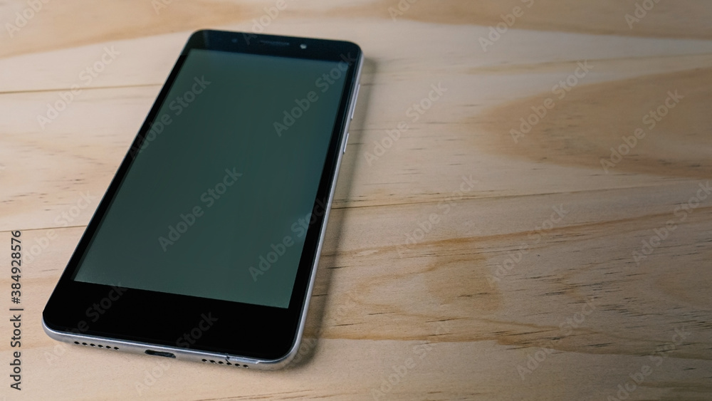 mobile phone on wood table for communication content.