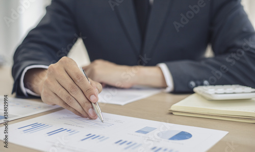 Finance workers are analyzing data in a private office.