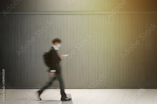 スマートフォンを見ながら歩くビジネスマン