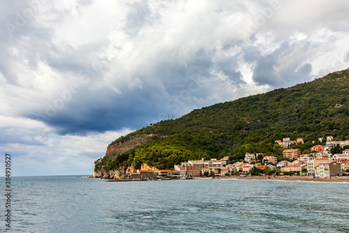 Public beach of Petrovac town with fortress.  photo