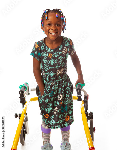 Black girl with Cerebral Palsy, in her walker, on a white background. 