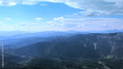 Landscape of scenic mountain forest background and peak of blue rock range.