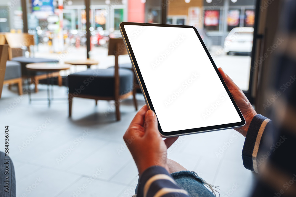 Mockup image of a woman holding digital tablet with blank white desktop screen Mockup image of a woman holding digital tablet with blank white desktop screen