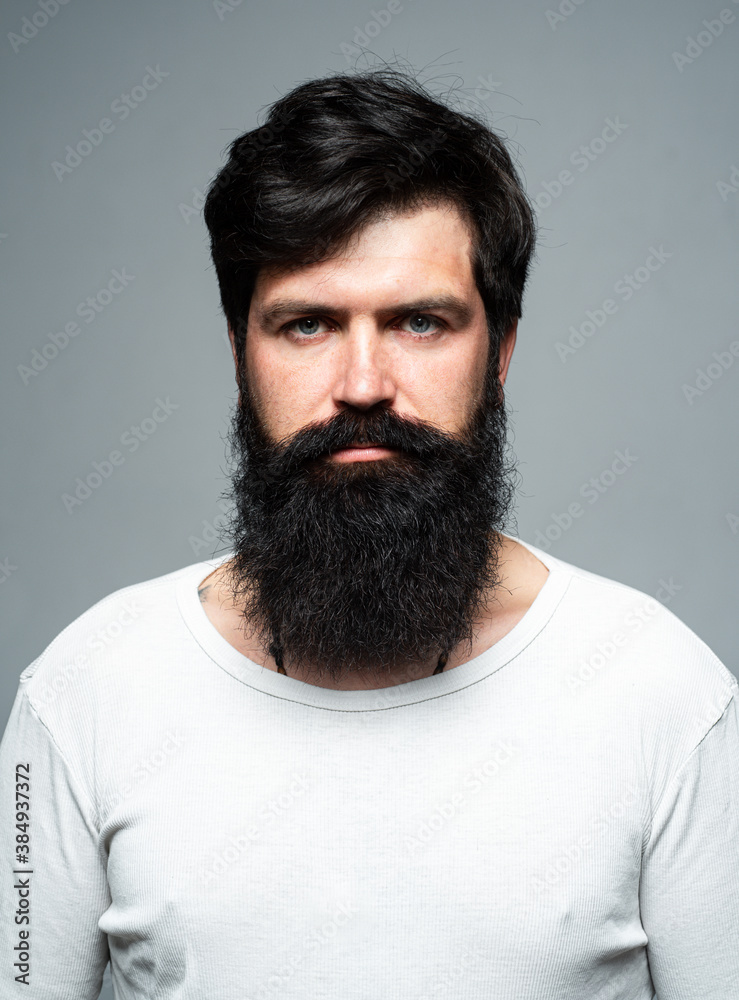 Obraz premium Barber with long beard and moustache in barbershop. Bearded man.