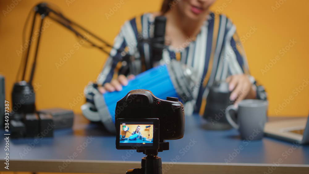 Close up of influencer recording on camera video light review. Social media star making online interent content about professional video equipment for web subscribers and distribution Close up of influencer recording on camera video light review. Social media star making online interent content about professional video equipment for web subscribers and distribution