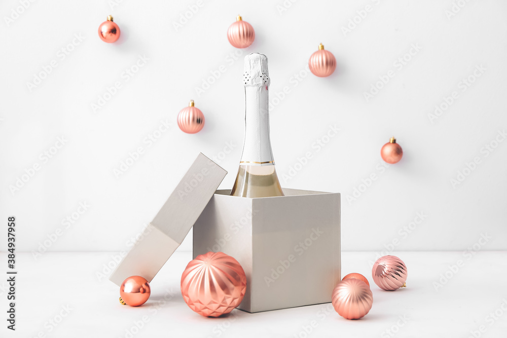 New Year composition with bottle of champagne on light background - obrazy, fototapety, plakaty 