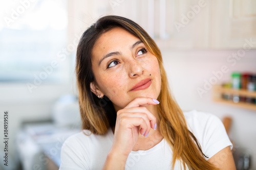 Positive latino housewife standing at home kitchen Free Download Positive latino housewife standing at home kitchen - GFXLoad