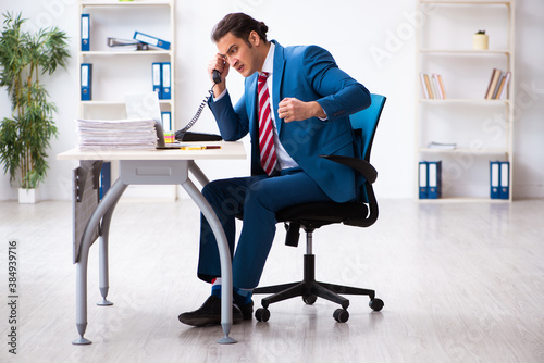 Young male employee working in the office