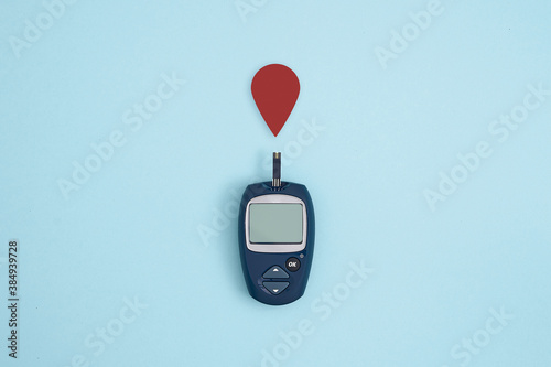 Принти на полотні Glucose meter and blood drop on blue background, Metabolic syndrome concept