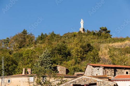 Usson, France. The Vierge Monumentale (Monumental Virgin), a large statue of the Virgin Mary overlooking the village of Usson photo