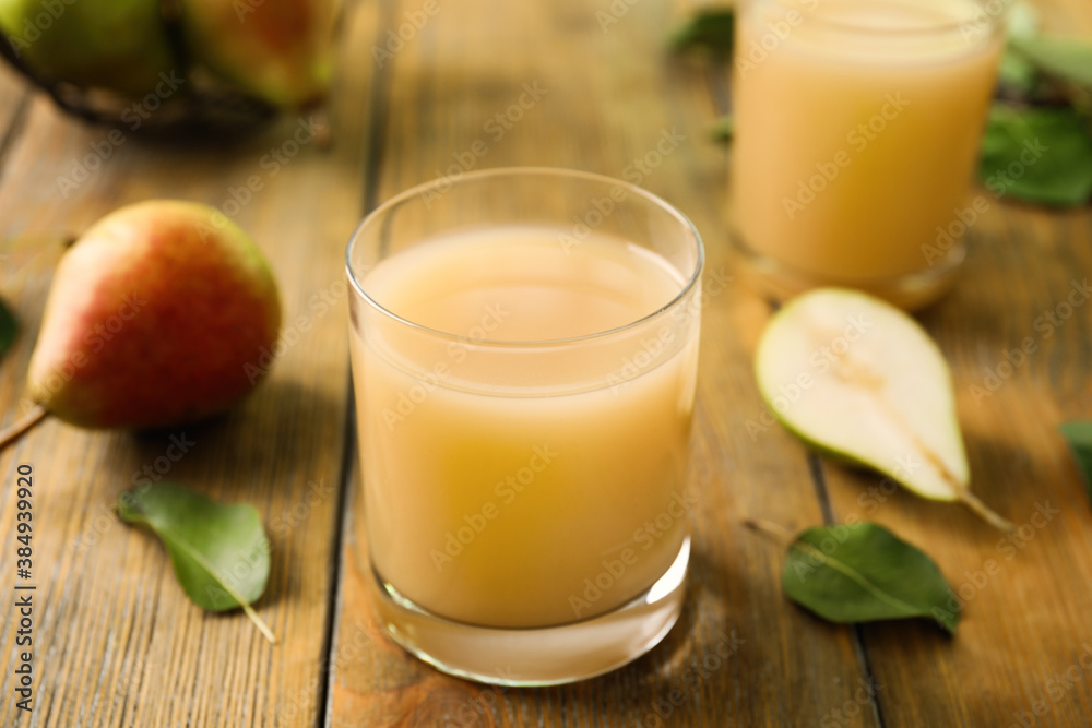 Fresh pear juice in glass on wooden table, closeup Fresh pear juice in glass on wooden table, closeup