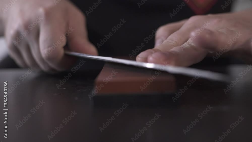 Male Chef Sharpening Butcher Knife in the Kitchen. 50 fps. Close up. Male Chef Sharpening Butcher Knife in the Kitchen. 50 fps. Close up.