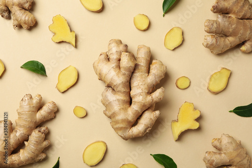 Fotografia Fresh ginger and leaves on beige background, top view