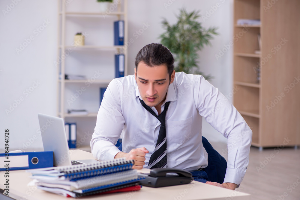 Fototapeta premium Sick male employee suffering at workplace