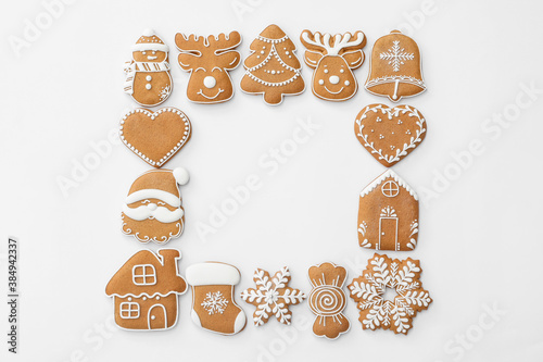 Frame made with different Christmas gingerbread cookies on white background, top view. Space for text