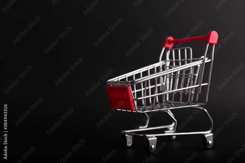 Black Friday concept. Empty shopping cart isolated on black background Black Friday concept. Empty shopping cart isolated on black background