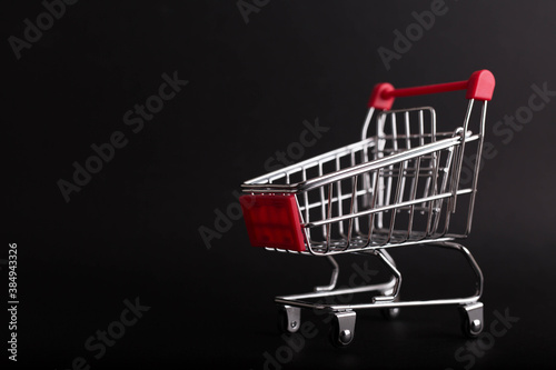Black Friday concept. Empty shopping cart isolated on black background