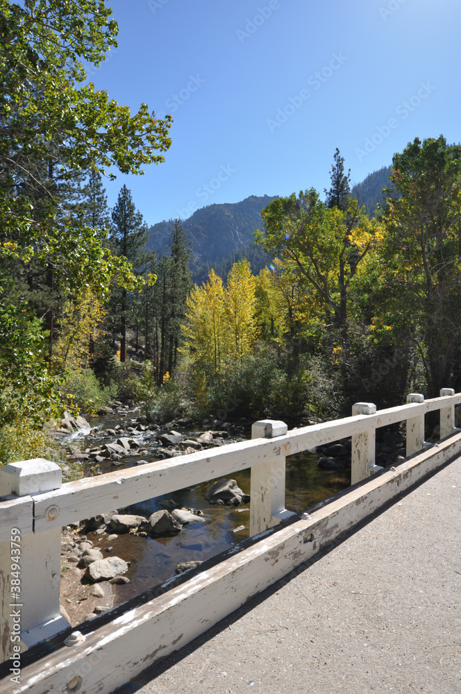 Vertical shots of a bridge over a river, and mountains framed by fall colors in the background