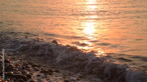 Amazing sunrise over the beach. Yellow golden sun over sea. Orange colors waves. Nature background. Beautiful scene. Morning. Sunlight reflect on water surface