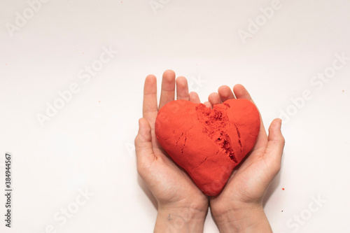 heart of red kinetic sand on a white background. the concept of Valentine's day