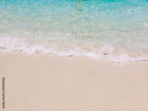 Soft wave of blue ocean on sandy beach with copy space. Background, Wallpaper