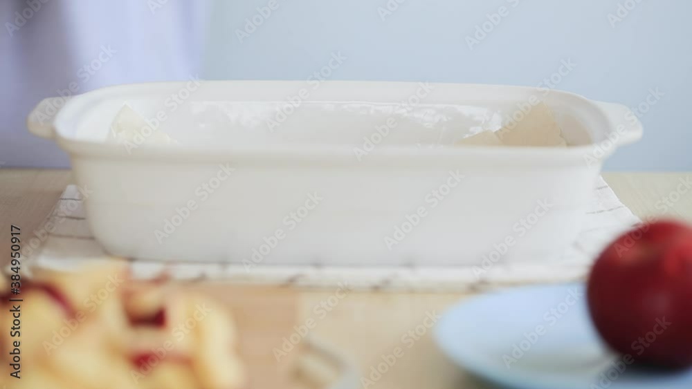 Cooking Apple Pie (Charlotte) - in a ceramic white baking dish. Cooking Apple Pie (Charlotte) - in a ceramic white baking dish.