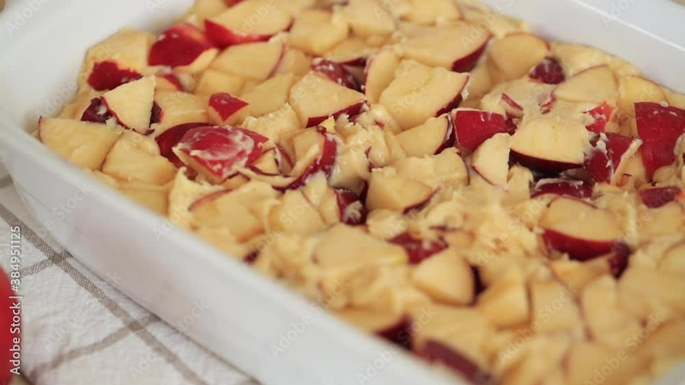 Cooking Apple Pie (Charlotte) - in a ceramic white baking dish. Cooking Apple Pie (Charlotte) - in a ceramic white baking dish.