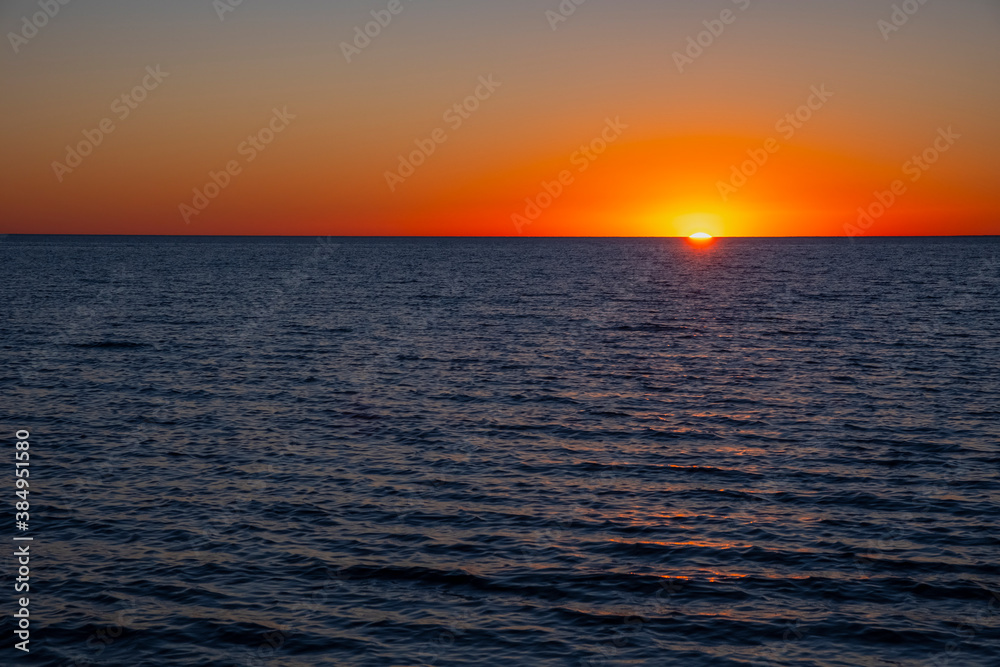 Beautiful sunset on the sea with golden sky, great design for any purposes. Summer nature landscape. Travel concept background. Sea landscape.