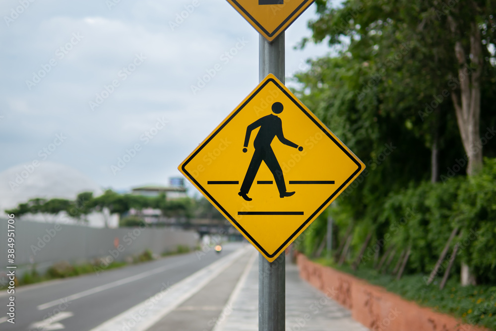 Pedestrian crossing sign beside the road