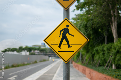 Pedestrian crossing sign beside the road