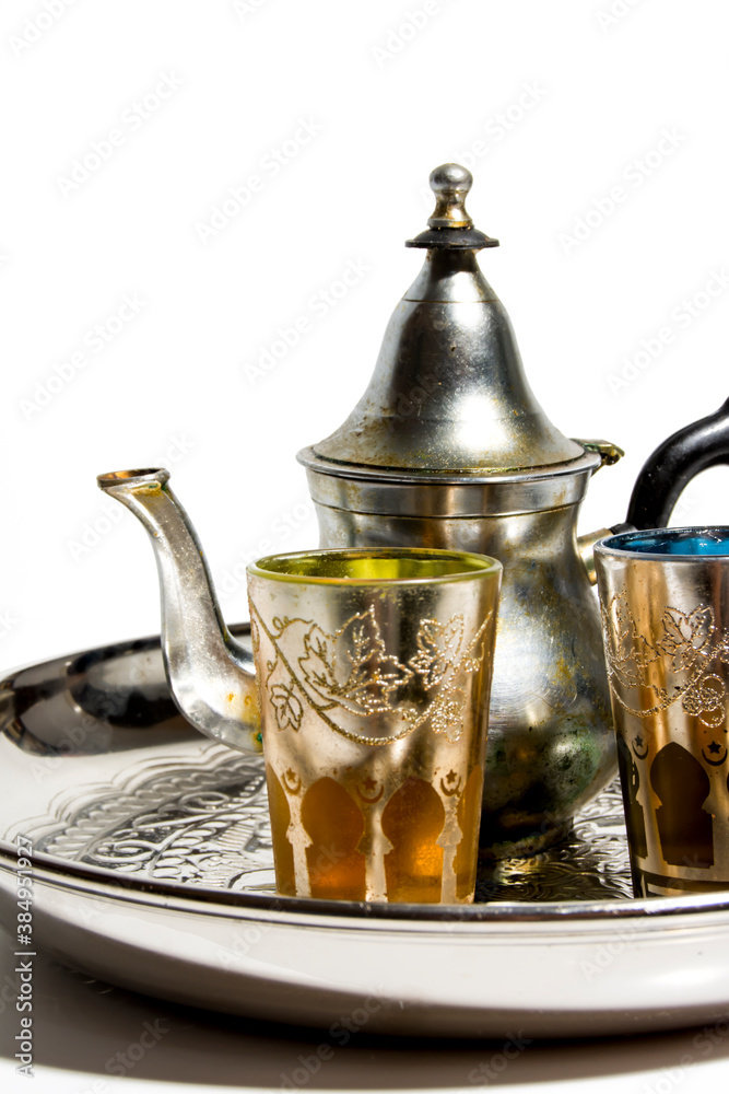 Group of teapot and glasses of oriental tea on a tray on white background Group of teapot and glasses of oriental tea on a tray on white background