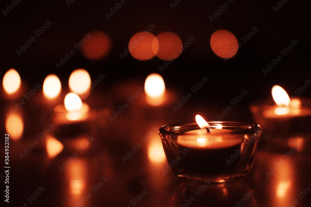 Candle light in Glass cup decoration in spa and christmas night party in Bokeh background. Holiday and Romantic love on valentines day Concept.