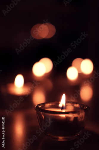 Candle light in Glass cup decoration in spa and christmas night party in Bokeh background. Holiday and Romantic love on valentines day Concept.