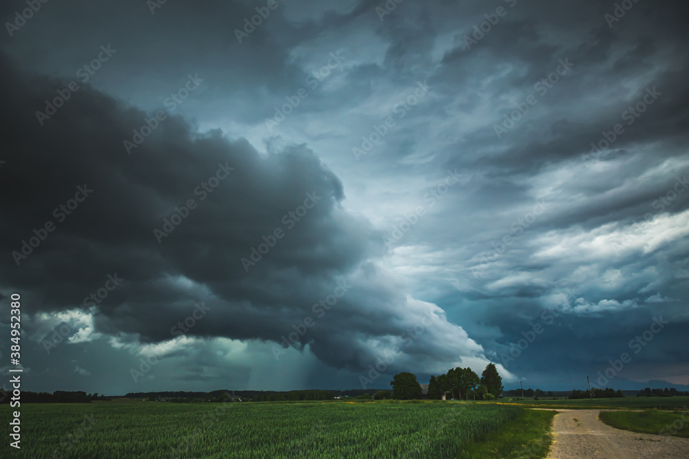 Supercell storm clouds with wall cloud and intense rain Supercell storm clouds with wall cloud and intense rain