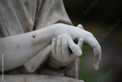 Victorian cemetery pieta statue hands of Jesus and Mary in white stone. Full frame, shot in natural light with copy space.