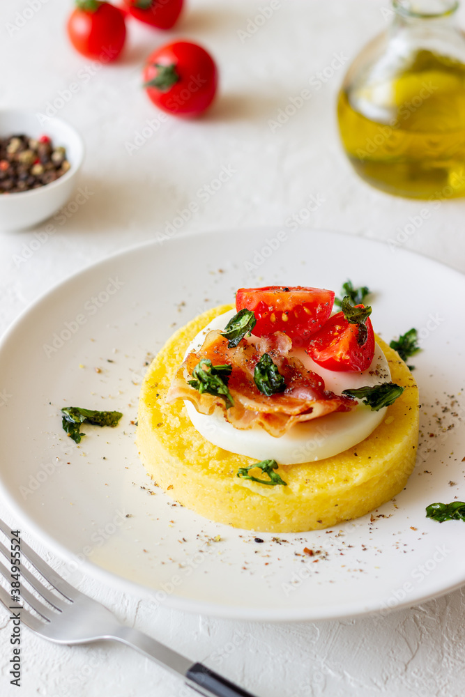 Polenta with mozzarella, bacon and tomatoes. Italian cuisine. Recipe. Polenta with mozzarella, bacon and tomatoes. Italian cuisine. Recipe.