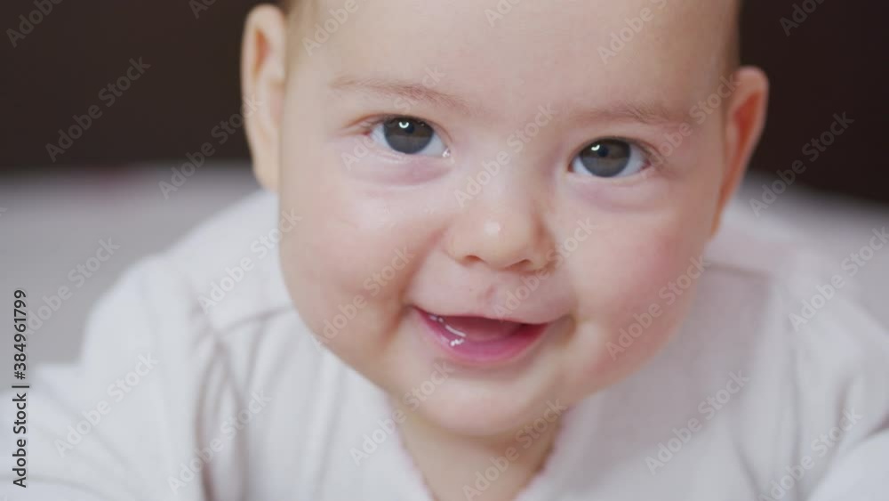 Close up slow motion of lovely little baby girl smile indoor portrait of infant smile. Close up slow motion of lovely little baby girl smile indoor portrait of infant smile.